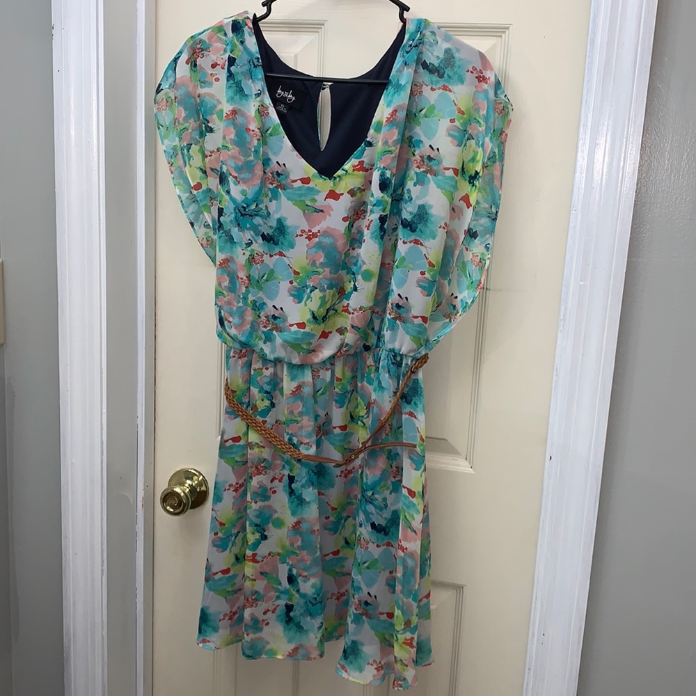 Beautiful floral dress made of sheer polyester with a navy polyester lining.